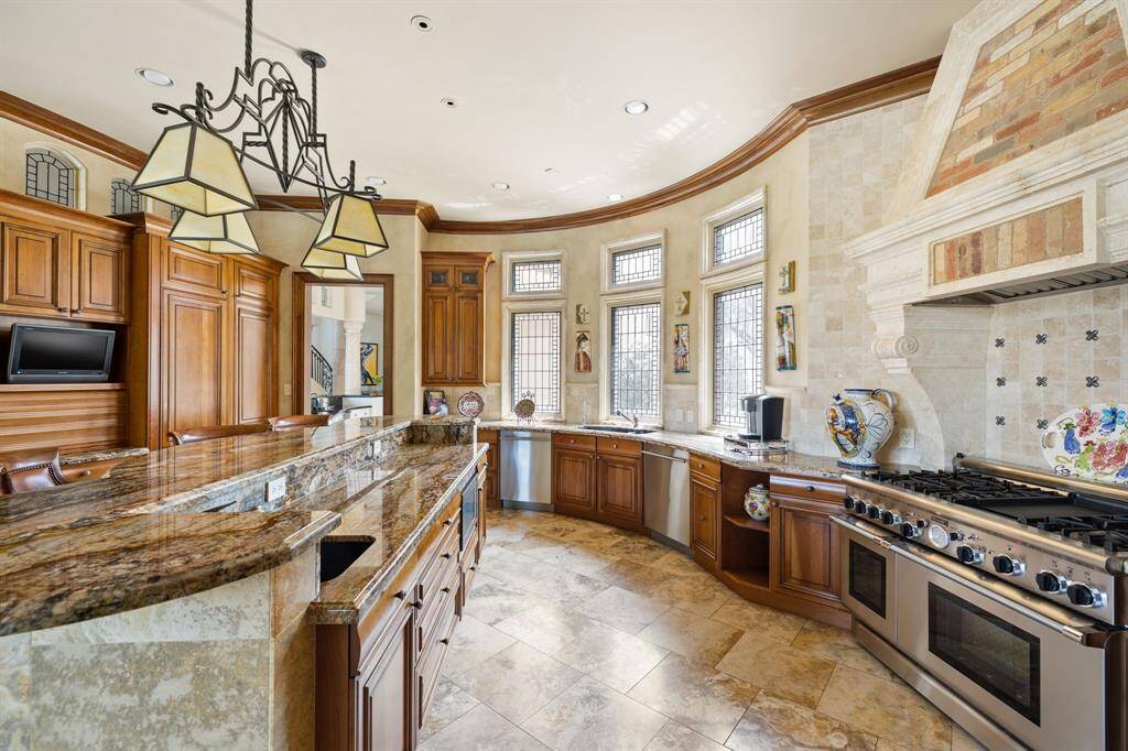 [Kitchen] No great Italian villa is complete without a una bella cocina! This Connoisseur's Kitchen includes: granite countertops, Scotsman ice machine and Subzero beverage refrigerator. The Island accommodates counter-height seating for four. Also included within is a 600-bottle climate controlled walk-in wine cellar with custom iron door.
