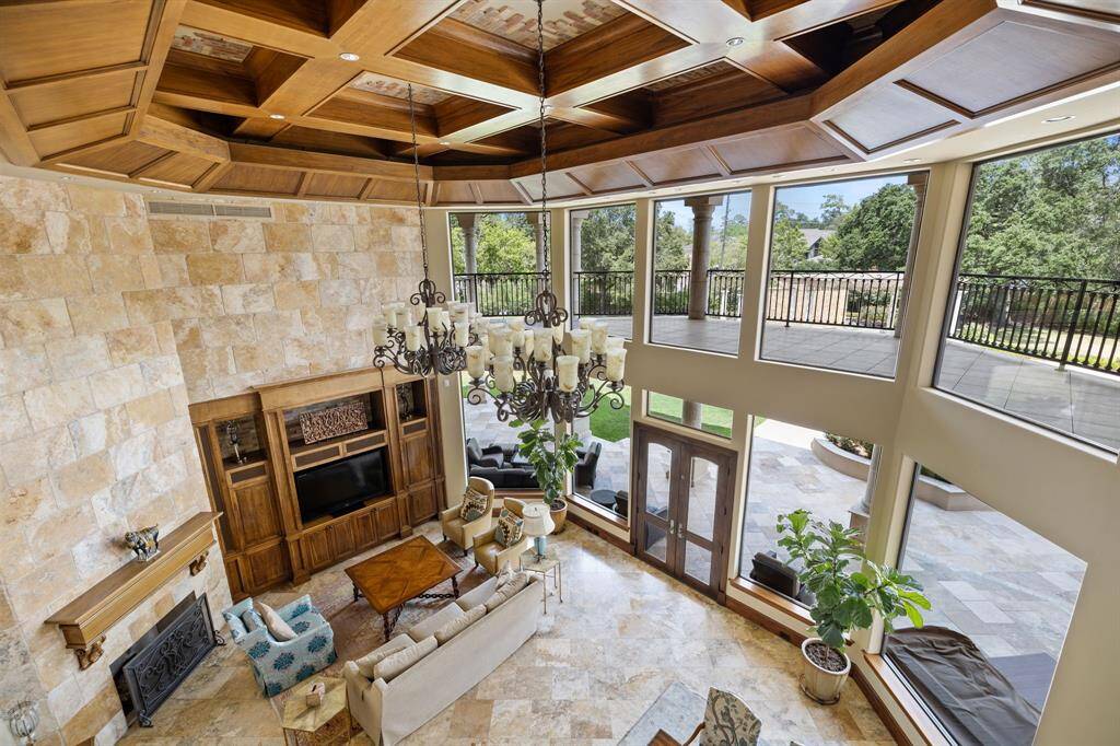 [Great Room] Let us retreat to the Great Room with its tumbled stone accent wall and a gas log Fireplace accentuated with a stately mantle, entertainment center and rustic stonework.