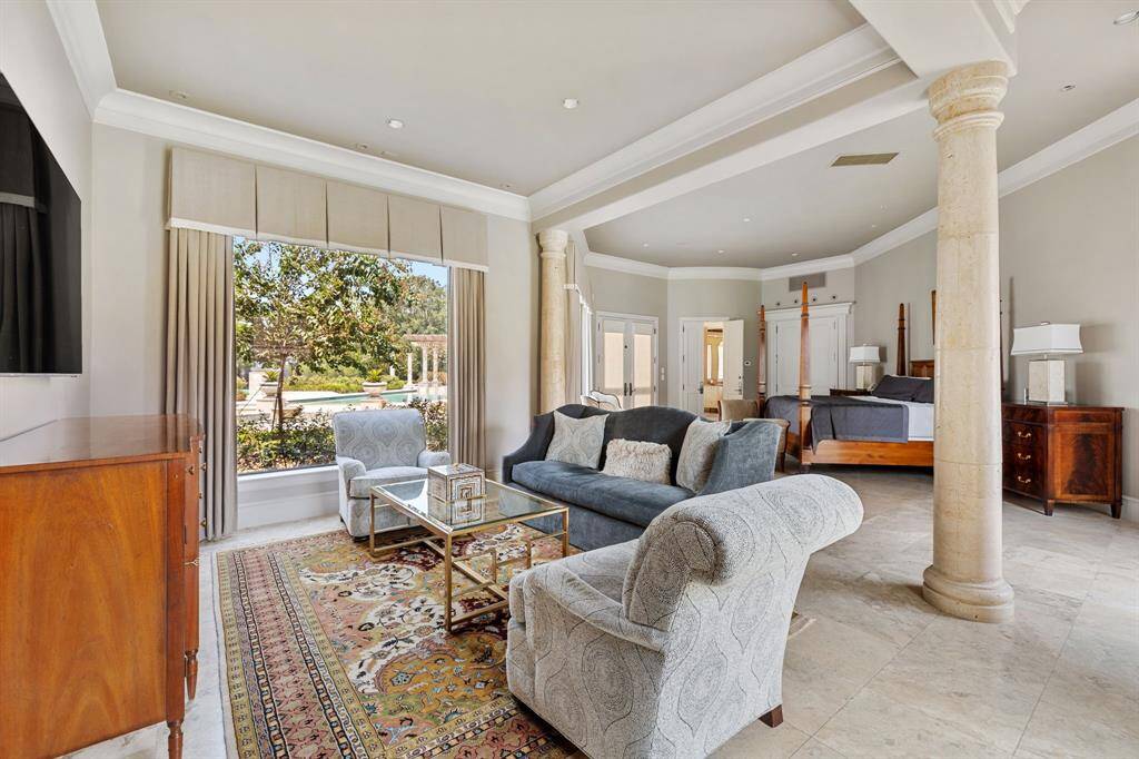 [Hallway] On the final axis of the Grand Foyer is an artful, private hallway that welcomes you to the secluded Master Suite. A gorgeous custom leaded glass window adds prisms of clear light to the space.