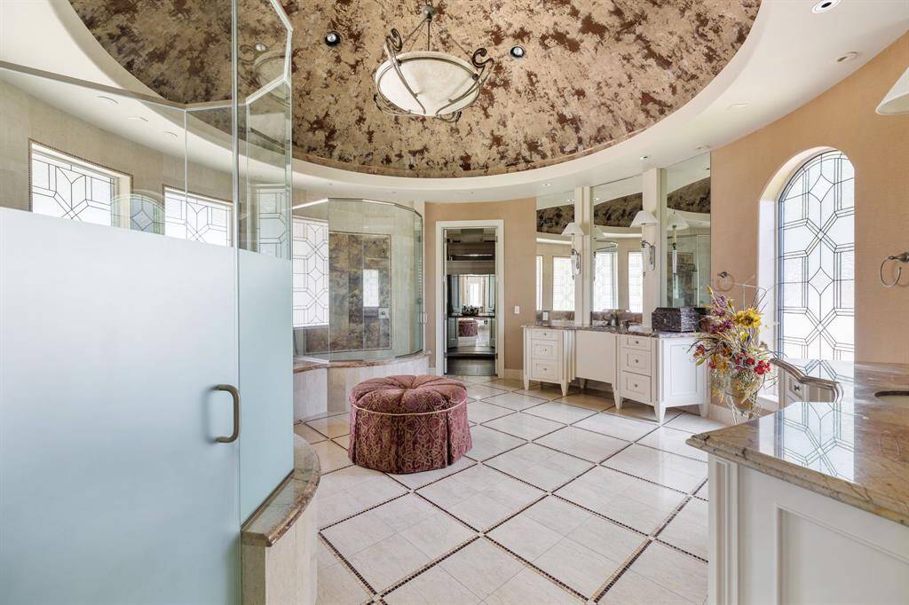 [Master Suite] The Sleeping Chamber of the Master Suite has three sets of French doors. The first set—with glass panes leads to the Pool and Gardens; the second set of French doors grants entry to the Master Bathing Spa. Behind Door #3 is access to a fully accoutred Morning Bar.