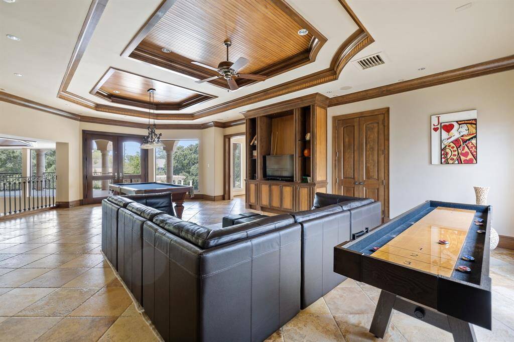 [Game Room] In the Hub of the Second Floor is a Lounge area with a Kitchenette, Wet Bar and beautiful architectural elements.