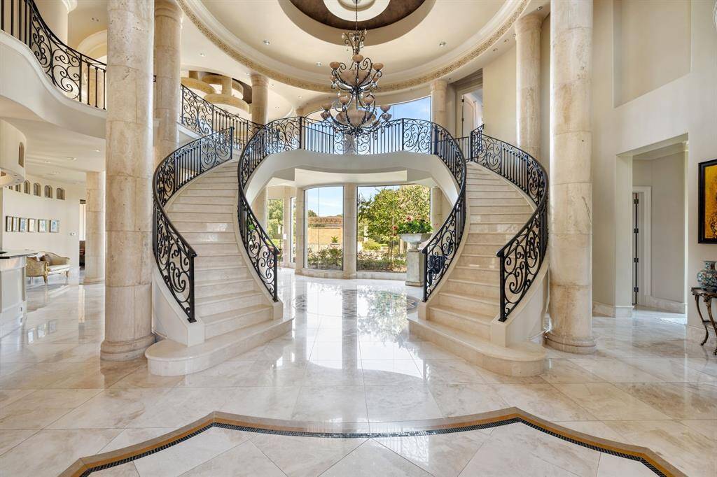 The Porte Cochère stands as a timeless symbol of elegance, ensuring that your first impression is one of grandeur and comfort through the 10' double-door entry adorned with patterned glass and wrought-iron.