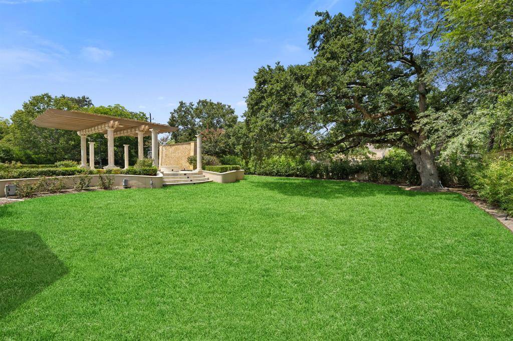 Beyond the formal Gardens and Pool is a green space on the lot, which spans 1.19 acres.