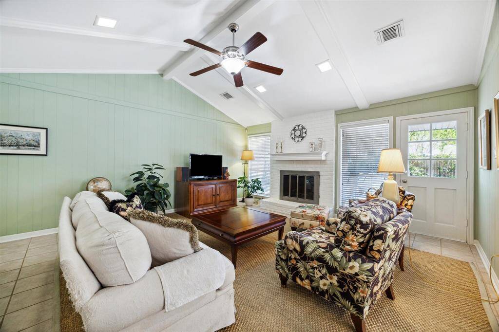 Another view of the living room and fireplace with wood mantel