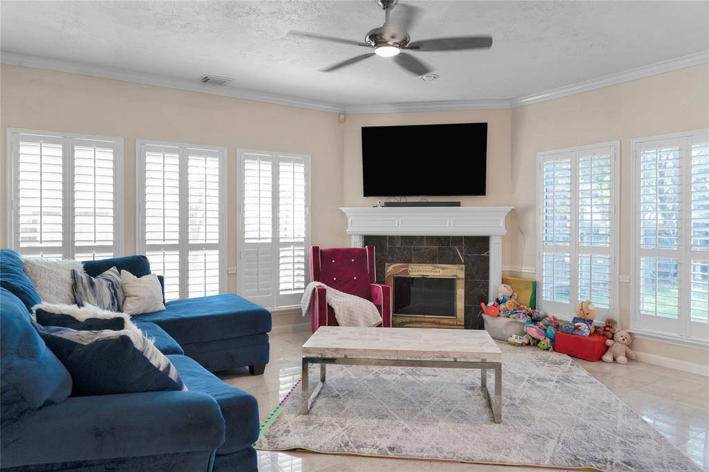 Look at all the windows with planting shutters with the cozy fireplace to unwind.