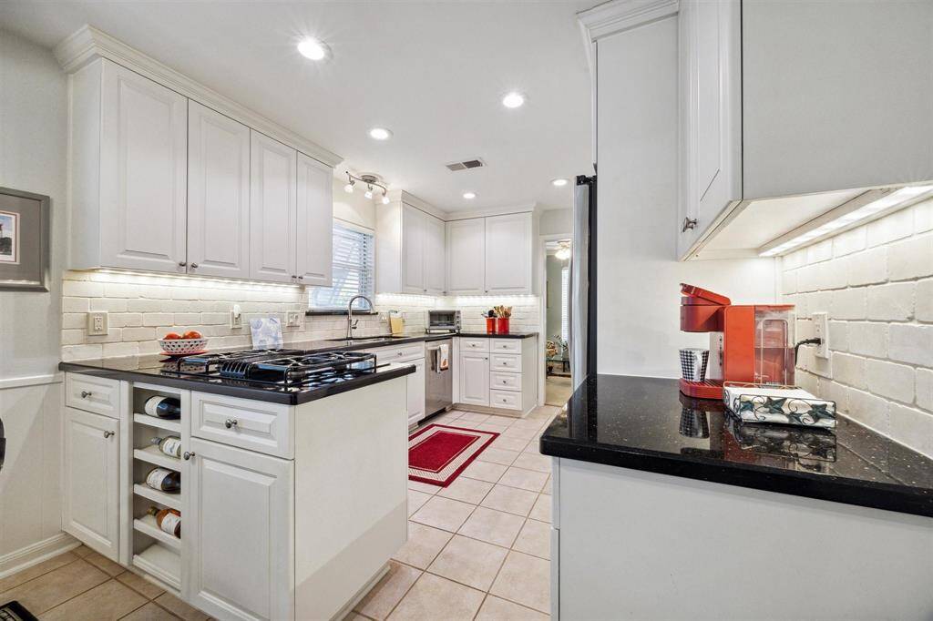 The kitchen has modern appliances and plenty of storage and workspace space