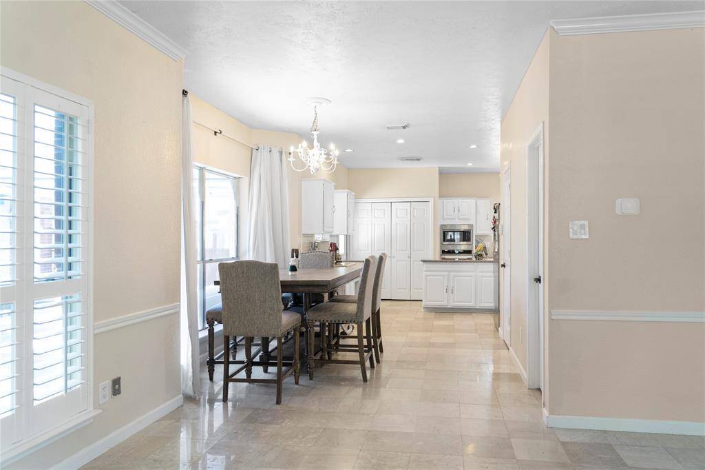 The dining area is positioned next to a bay window or overlooks the backyard, allowing plenty of natural light to fill the space.
