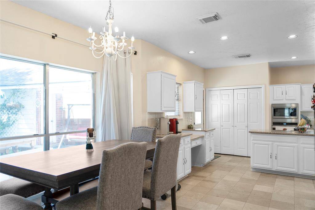 The dining area is positioned next to a bay window or overlooks the backyard, allowing plenty of natural light to fill the space.