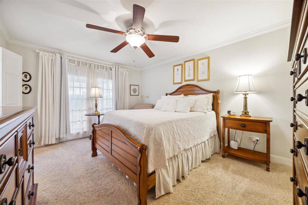 The primary bedroom is light and bright with French doors out to the back yard