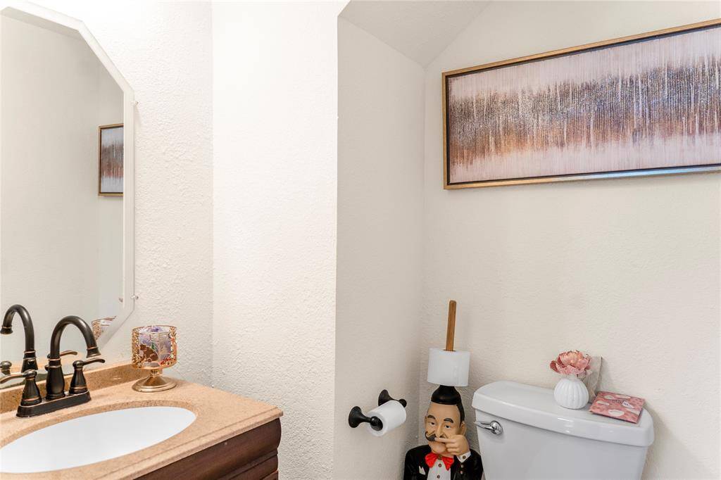 A half bath/powder room is conveniently located downstairs for easy access.