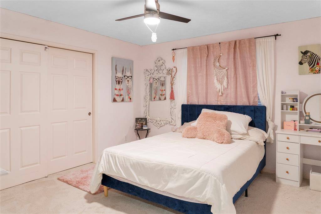 The second bedroom is generously sized, creating an inviting atmosphere that combines comfort and functionality. The room features large windows that allow natural light.