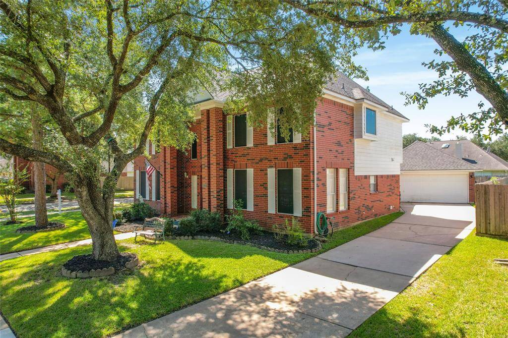 A long driveway along the side of the house, capable of accommodating multiple cars.