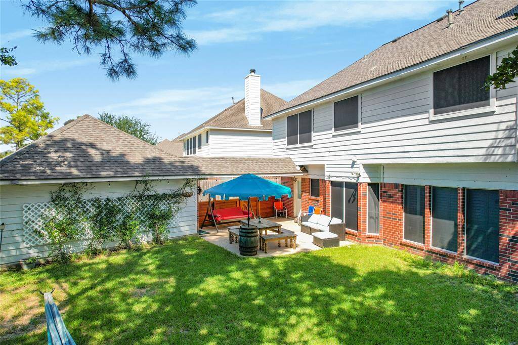 Imagine stepping into a spacious backyard that serves as an inviting retreat for relaxation and outdoor gatherings.