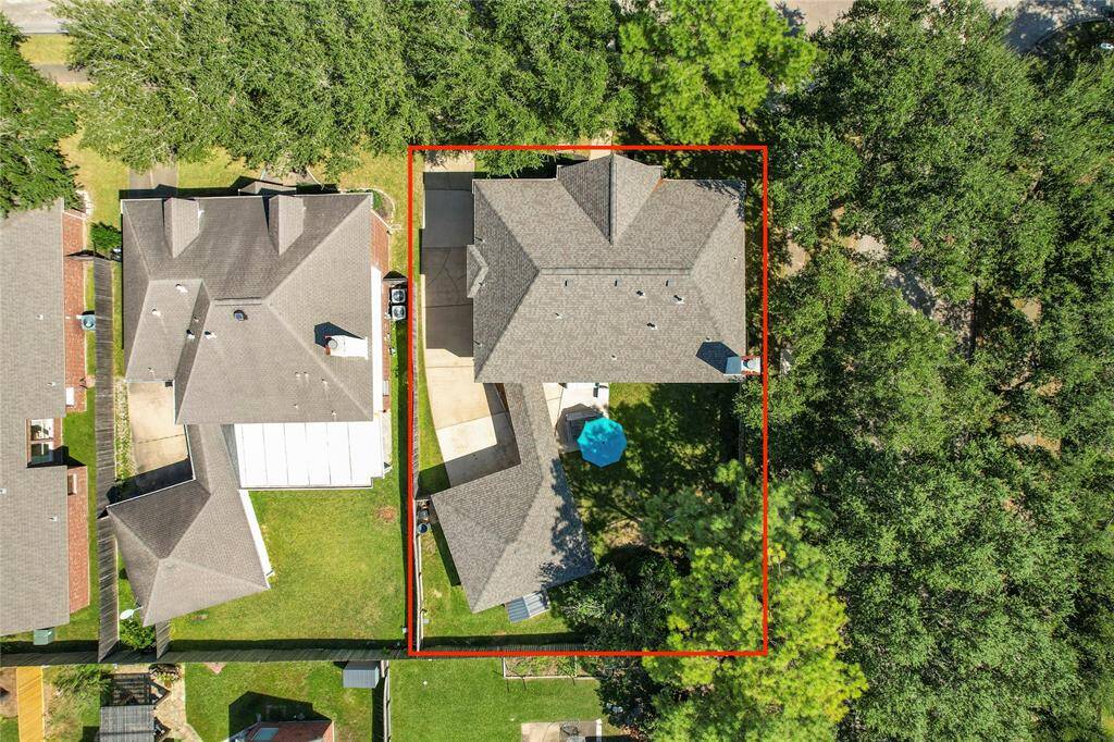 The aerial view showcases a beautifully designed home set in a picturesque landscape.