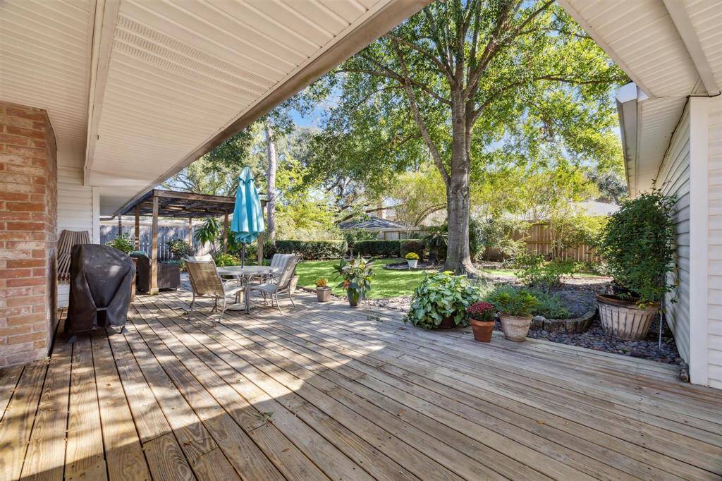 Covered decked patio and large yard for tranquil back yard space