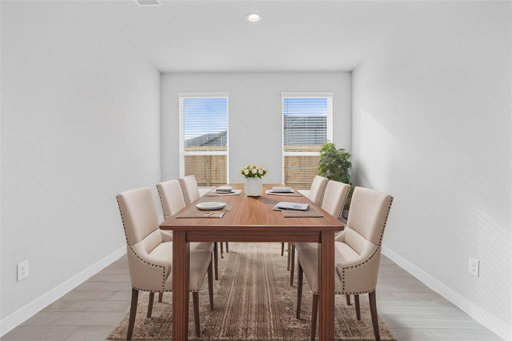 Make memories gathered around the table with your family and friends! This dining room features high ceilings, large windows, recessed lighting and gorgeous tile flooring.