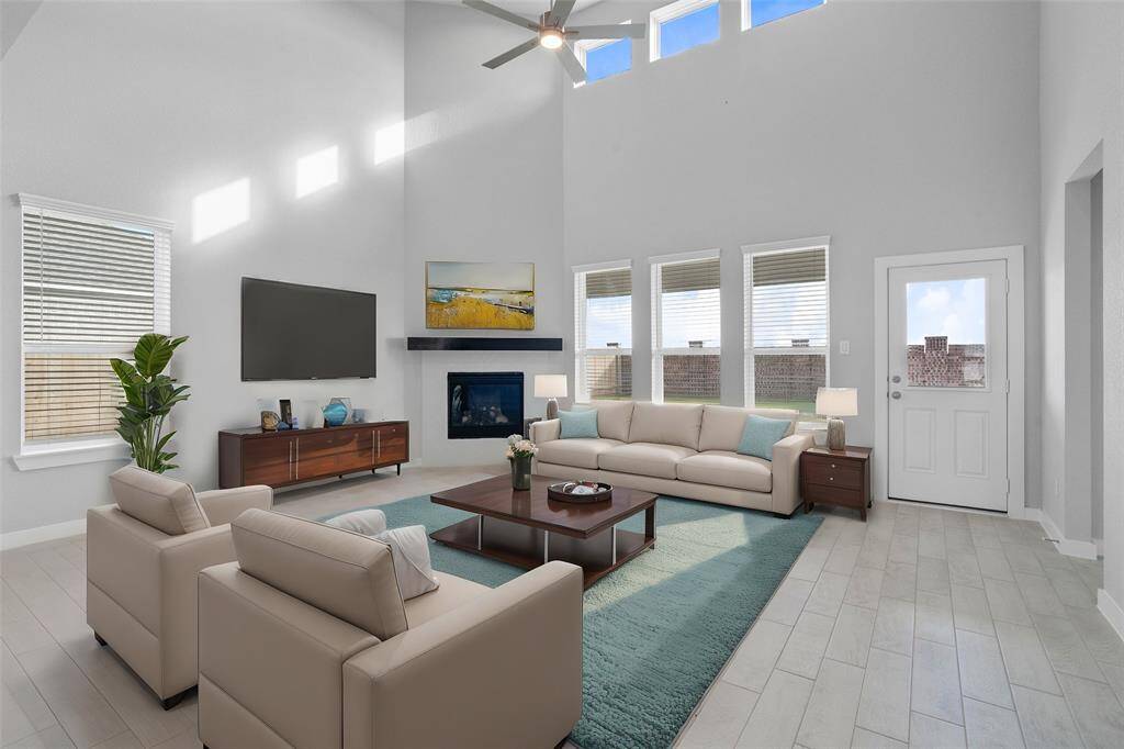 Gather the family and guests together in your lovely family room! Featuring a beautiful fireplace with wood mantel, high ceilings, ceiling fan, custom paint, gorgeous floors and large windows that provide plenty of natural lighting throughout the day.