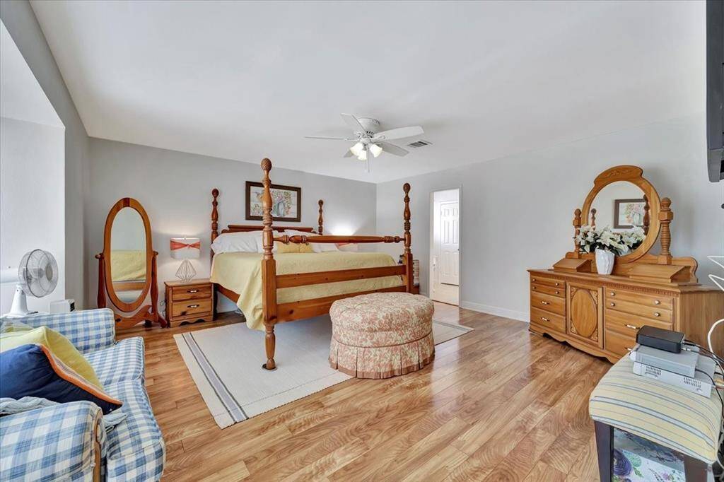 Another view of the primary bedroom.  All of the bedrooms are carpet free offering beautiful wood like flooring. You will also appreciate that there is NO popcorn ceilings!!