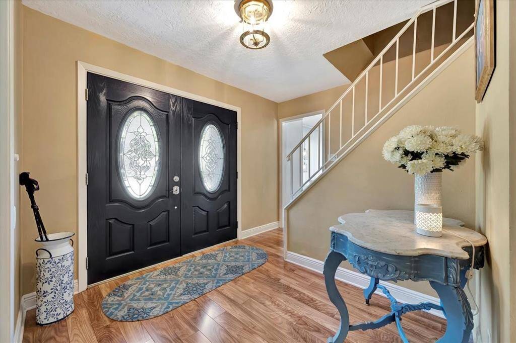 This oversized family room provides plenty of space for entertaining, with large windows that flood the room with natural light and a cozy fireplace as the focal point.
