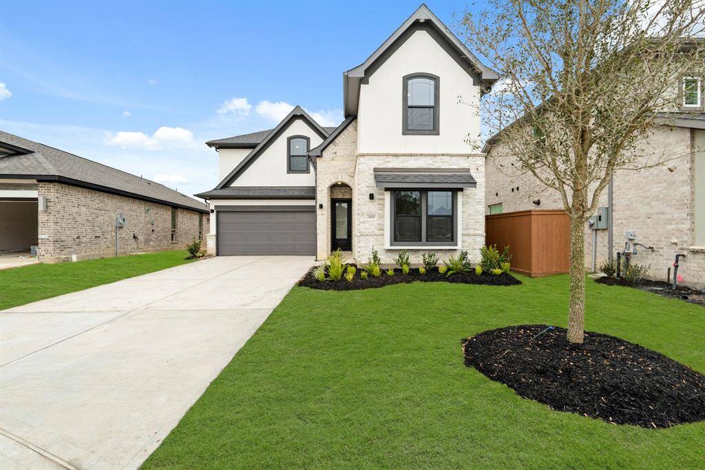 The Donley plan by Newmark Homes offers a stylish blend of brick, stone, and stucco, creating a timeless and elegant exterior with modern, open-concept living spaces.