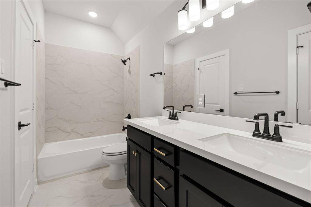 Jack and Jill bathroom between the secondary bedrooms, providing shared access with added convenience and privacy.