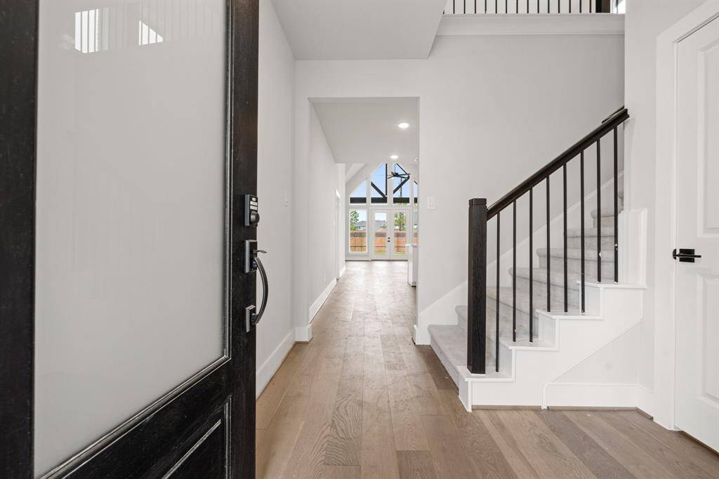The Donley plan features a well-designed entryway with ample storage under the stairs, maximizing space and functionality while maintaining a sleek and open feel.