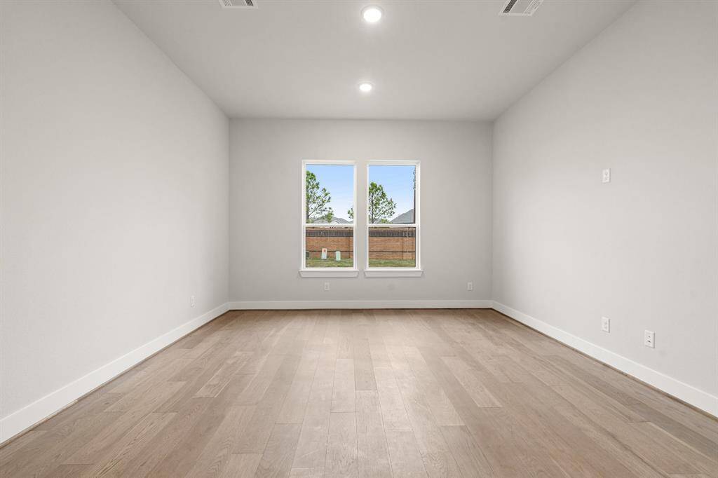 A spacious main bedroom with a serene retreat feel, designed for comfort and relaxation.