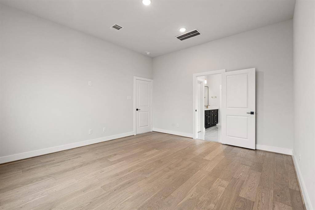 Double doors lead to the luxurious main bathroom in the Donley plan, offering a spa-like retreat with elegant finishes.