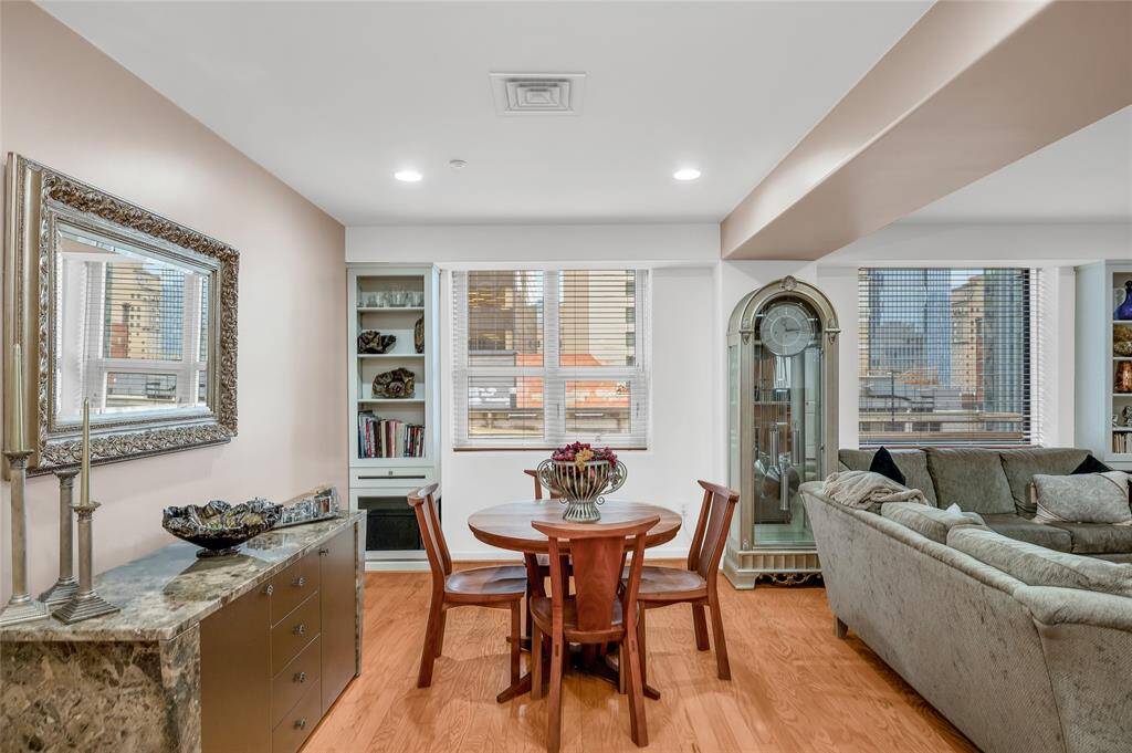 Two windows overlook Walker St and have wood tone 2" blinds covering them. Window on left has a section that tilts out to allow for air circulation if desired. Built-in shelving/storage flanks each window!  Note recessed lighting above!