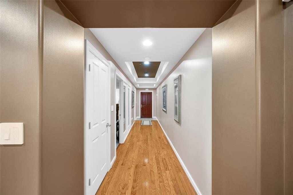 Impressive Gallery Entry Hallway can be personalized with your artwork or shelving. Near door on left is a storage closet. Open glass door and the fixed glass panels separate the Bedroom from Hallway. Far left door is Bathroom.