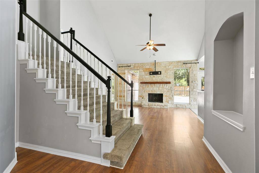 Extra nook by stairs to put storage piece. High end laminate floors installed for easy maintenance and upgraded look.