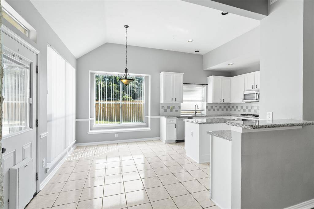 Roomy breakfast area overlooks the backyard. Ceramic tile is installed here and in kitchen-easy clean up!