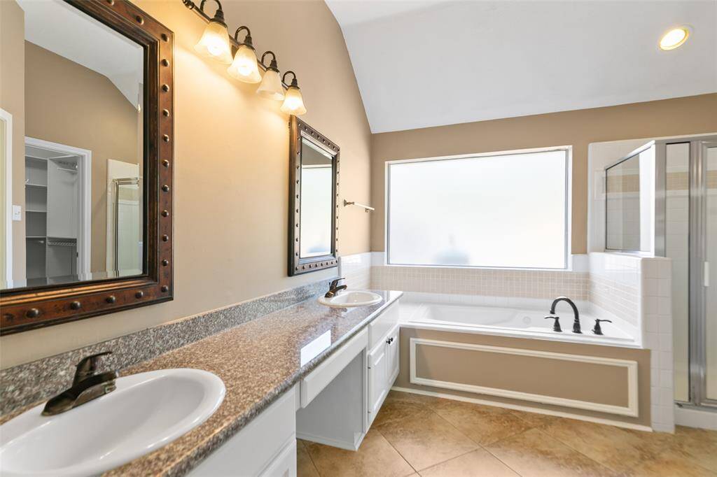Fantastically upgraded main bath with granite counters, double sinks and sit down vanity area.