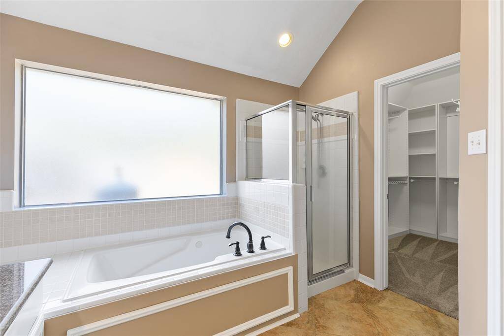 Large whirlpool bath with privacy window and separate shower. Nice sized walk in closet.