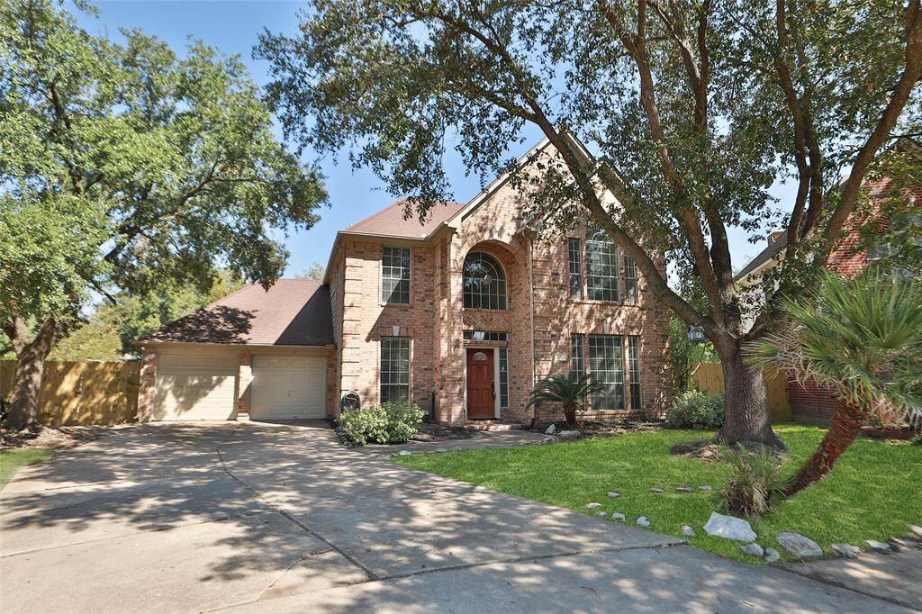 Extra long driveway leads to 2 car garage.New garage door opener installed. Mature landscaping and trees in front.