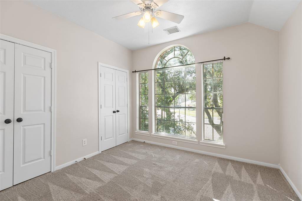 Secondary bedroom is nicely sized. Large window overlooking front yard.