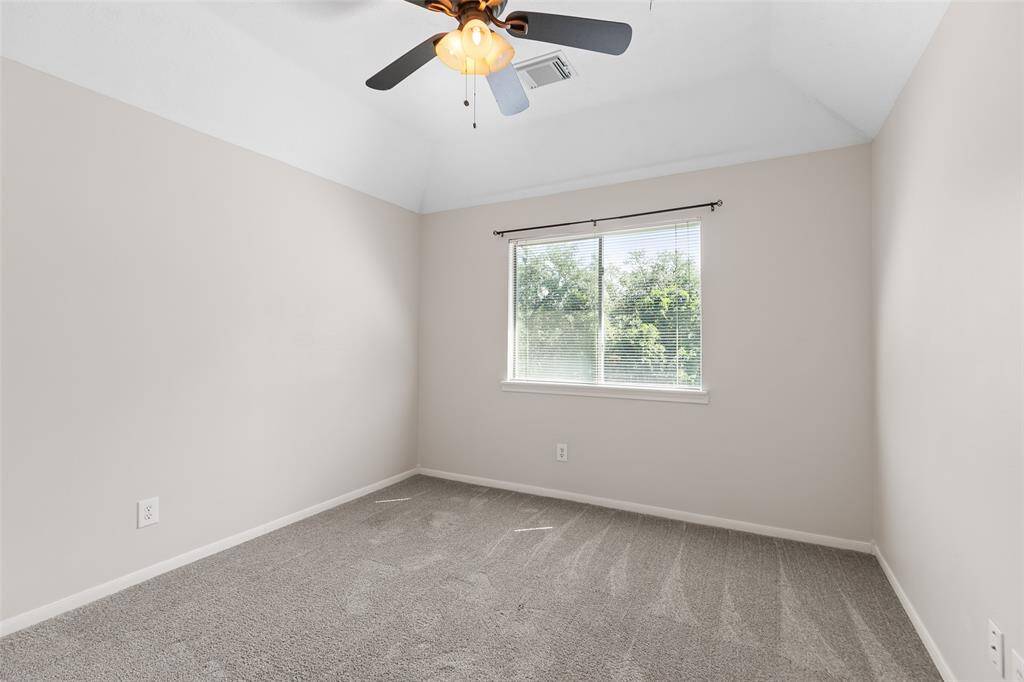 The third bedroom is also good sized with ceiling fan and curtains.