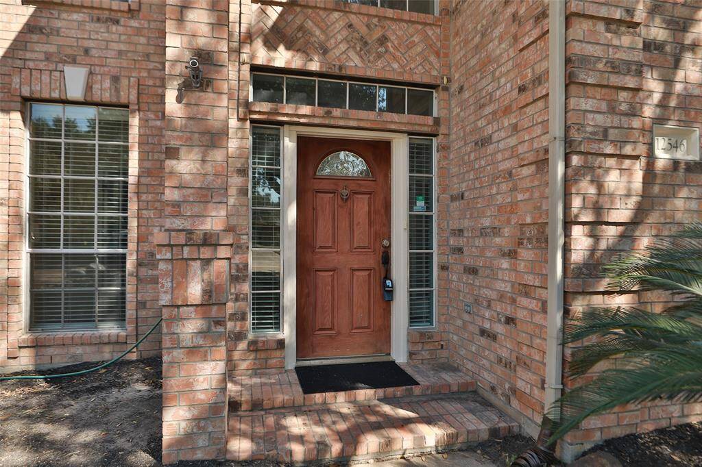 Front door has been restained to a darker color and new deadbolt added to match handle.