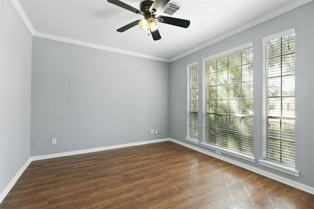 Ceiling fan, and wall of windows make for a cozy home office.