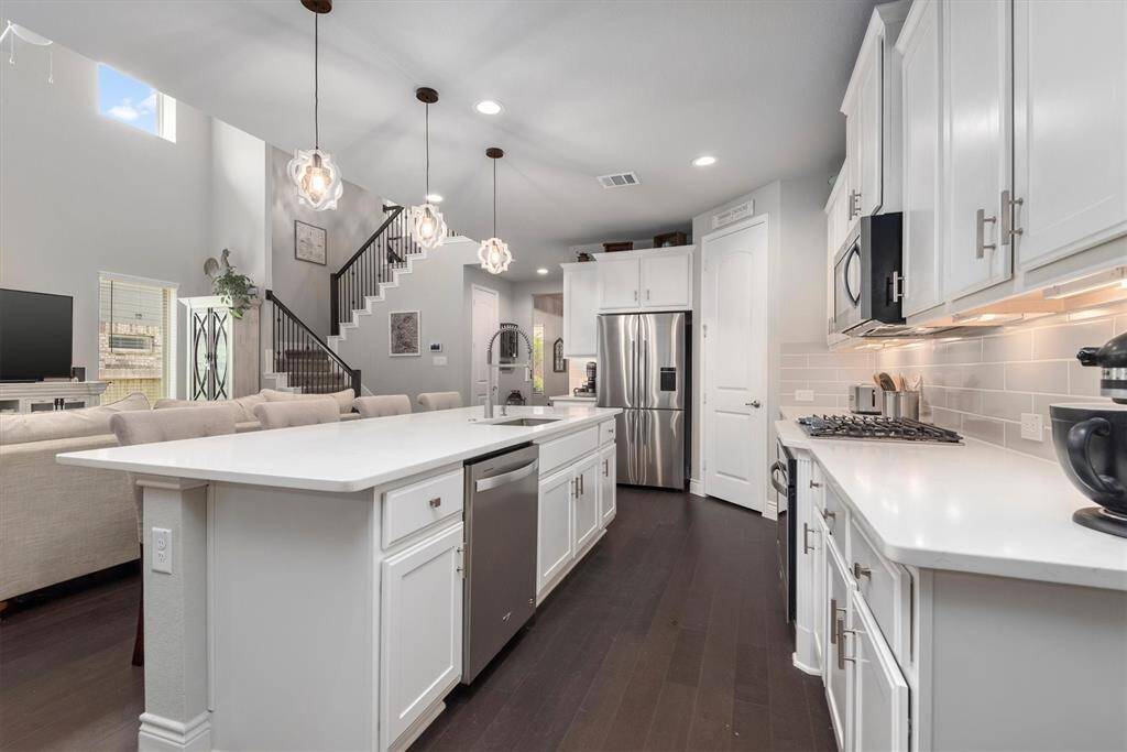 Beautiful kitchen with white cabinetry and huge island!