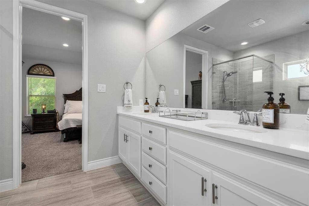 These double sinks are located in white cabinertry will lots of storage and drawers!
