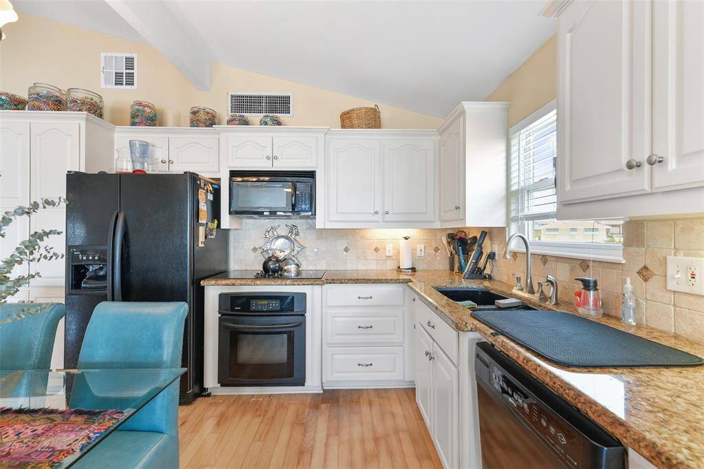 Step back look at the L Shaped kitchen. Add an island with designated seating to make less formal.