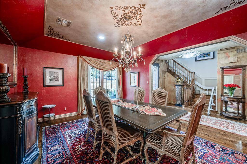 Textured walls and gold stenciled trayed ceilings give the dining room a refined look. Enjoy the floor to ceiling windows that flood the room with natural light.