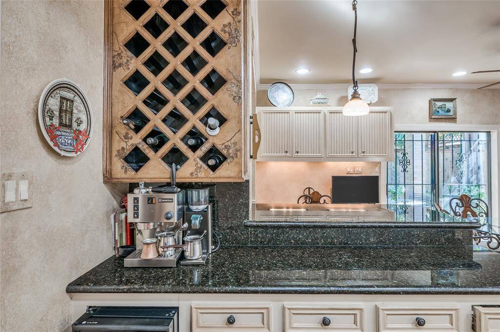 Custom built-in wine storage and an under counter U-line ice maker complete the breakfast bar. Adjacent to the kitchen is a large breakfast area, complete with built-in shelving and a convenient desk station with sufficient storage space.