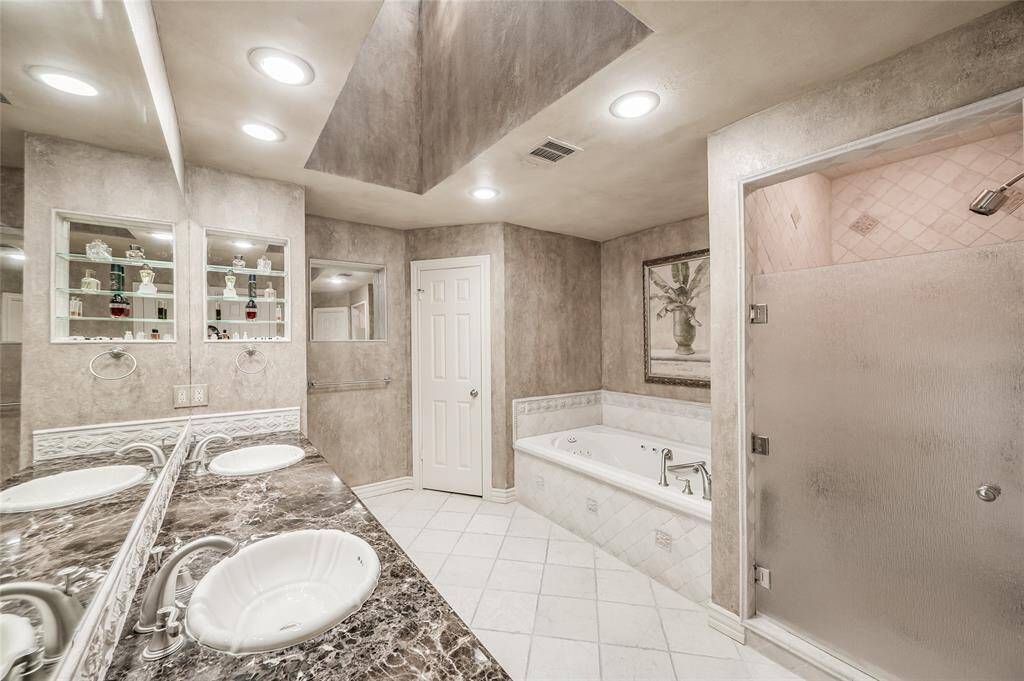 A large skylight bathes the primary bathroom in beautiful natural light.