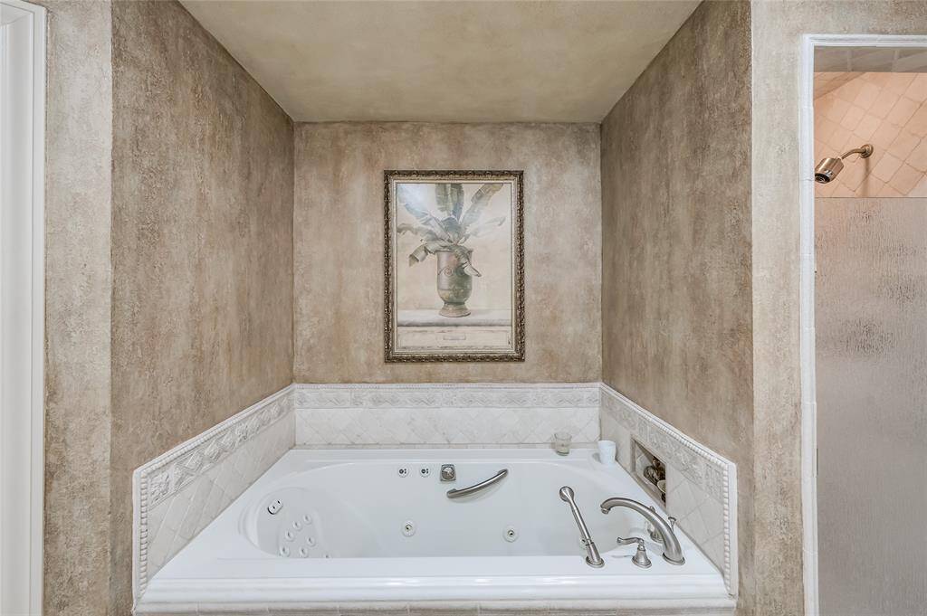 Relax and unwind in the spacious Spa-like Jacuzzi tub. The primary bathroom features two walk-in closets and a separate water closet.