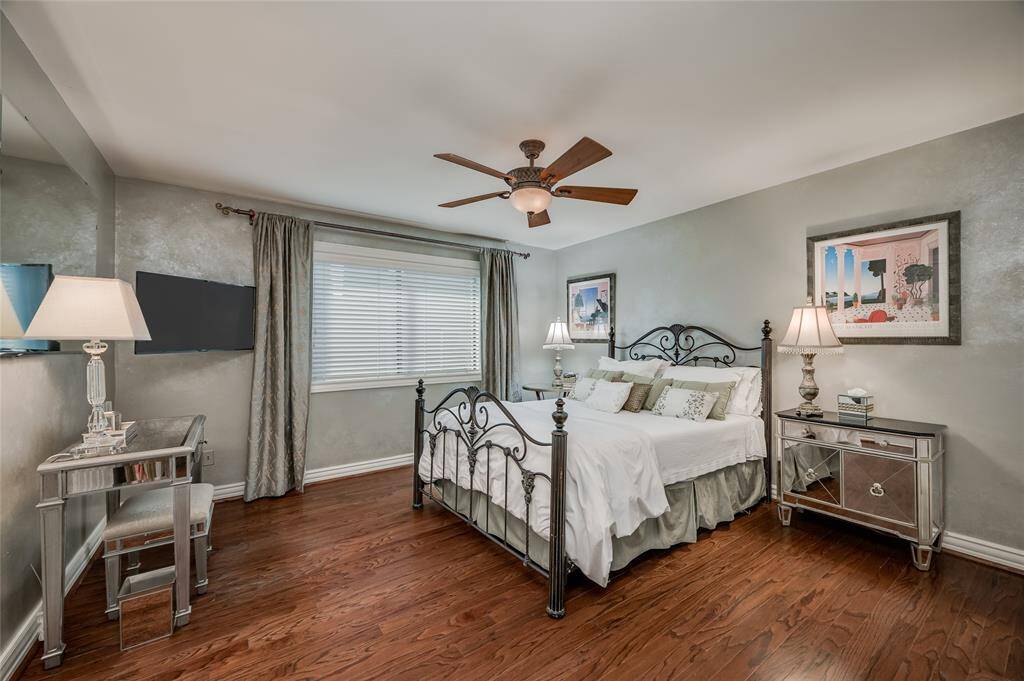 One of the three oversized secondary bedrooms features hardwood floors, crown baseboards, a ceiling fan, and access to the Hollywood bathroom. The custom silver glazed walls give a romantic feel.