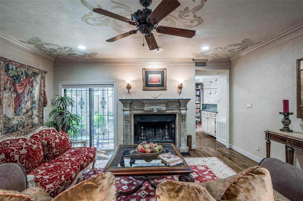 Admire the stately Ambella fireplace with its granite surround while enjoying serene views of the charming back patio.