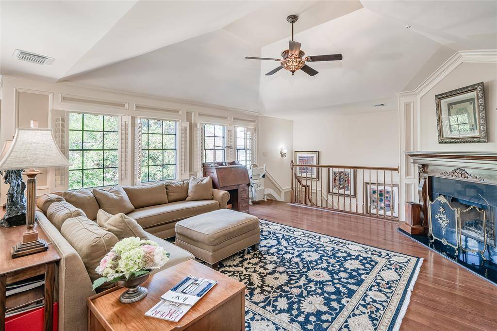 Upstairs, the spacious game room impresses with a fireplace featuring a granite insert and custom mantle reminiscent of the Biltmore Estate.