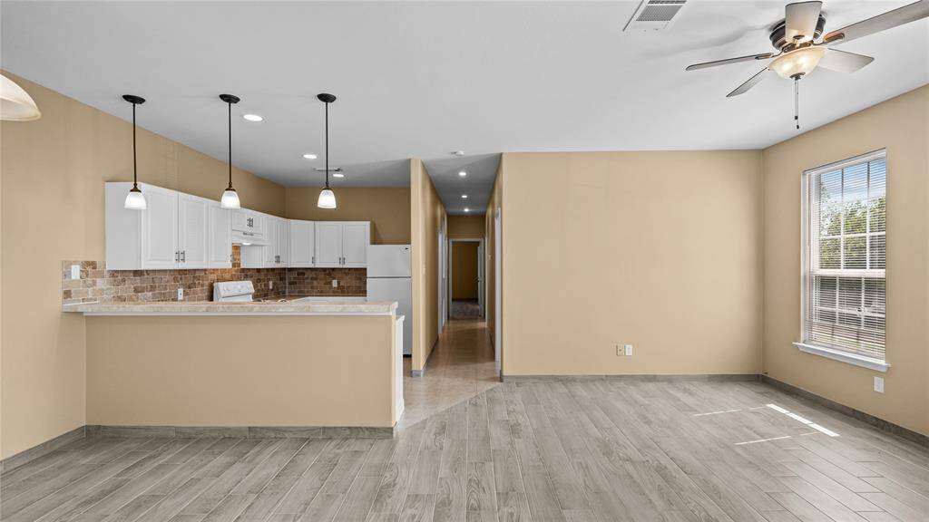 Entry into open living area, dining area and kitchen